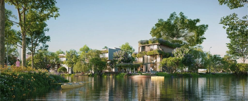 Các Loại Hình Biệt Thự Tại Alluvia City 3 Hình ảnh một khu biệt thự đảo tại Alluvia City, với những ngôi nhà hiện đại nằm giữa dòng sông, bao quanh bởi cây xanh tươi tốt và hoa cỏ rực rỡ. Một chiếc thuyền kayak màu vàng neo đậu trên mặt nước phẳng lặng, phản chiếu ánh sáng tự nhiên, tạo nên khung cảnh thanh bình và đẳng cấp dưới bầu trời xanh.
