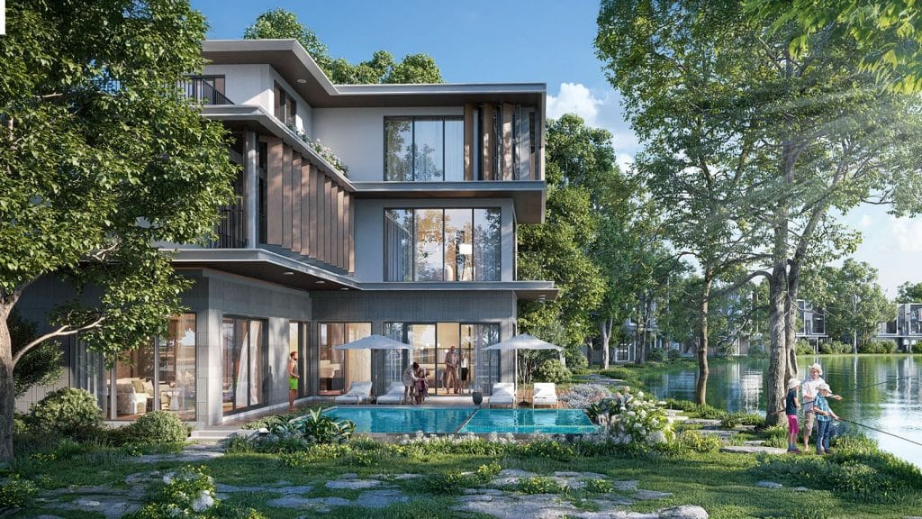 Các Loại Hình Biệt Thự Tại Alluvia City 5 Hình ảnh một biệt thự đơn lập tại Alluvia City với thiết kế hiện đại, bao quanh bởi cây xanh và hồ nước yên bình. Căn biệt thự có hồ bơi riêng, sân vườn rộng rãi, nơi một gia đình đang tận hưởng thời gian thư giãn bên nhau, với trẻ em câu cá và người lớn trò chuyện dưới bóng ô che nắng.