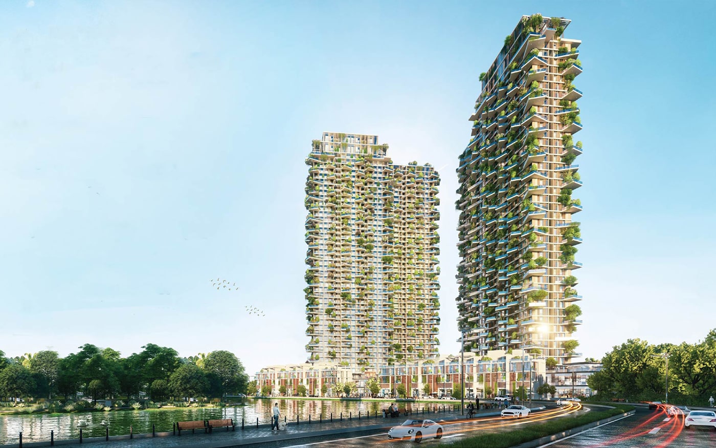 Alluvia City Văn Giang 17 Hình ảnh phối cảnh của hai tòa khách sạn cao tầng với các ban công xanh tại Alluvia City Văn Giang, có hồ nước, cây cối và con đường với xe cộ di chuyển phía trước.